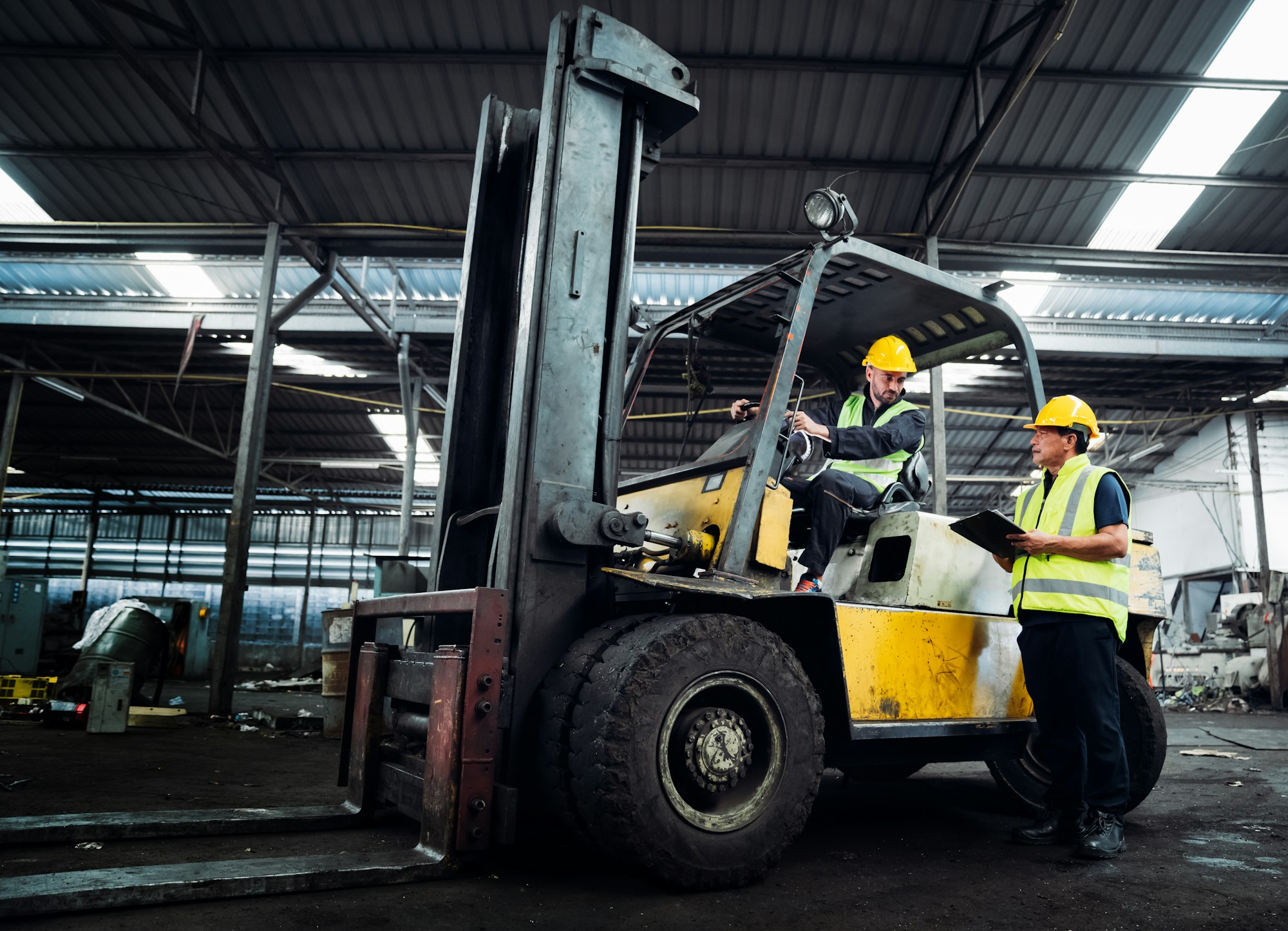 Industrious Engineer Operating Forklift in Warehouse. Efficient Forklift Driving in Factory.