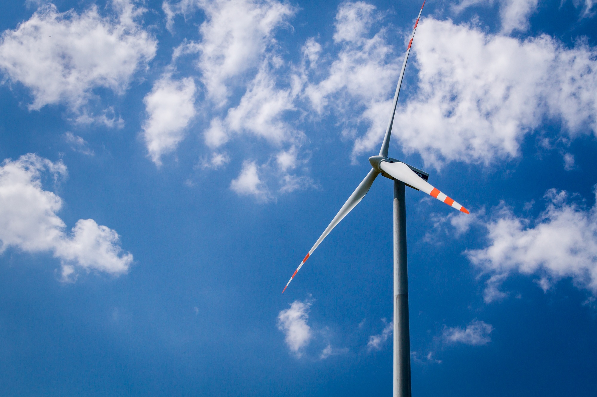 Wind turbine on blue sky background